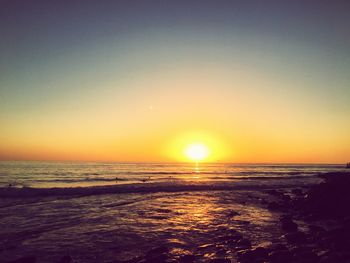 Scenic view of sea against clear sky during sunset