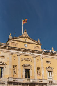 Low angle view of building against blue sky