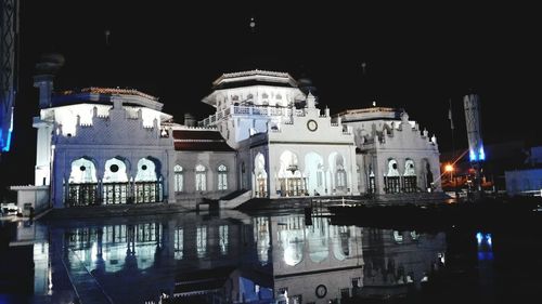 Reflection of illuminated buildings in city at night