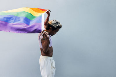 Rear view of woman standing against sky