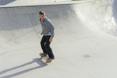 Man skateboarding on ramp in park