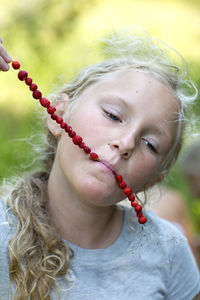 Girl eating wild strawberries