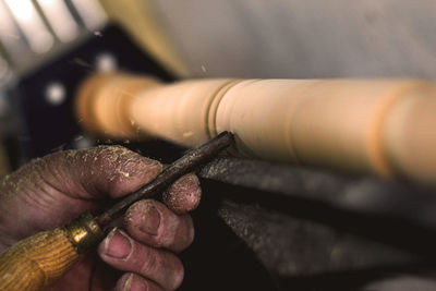 Cropped hand of carpenter working in workshop