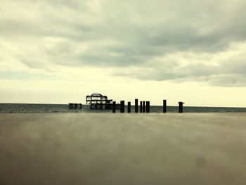 Lifeguard hut on beach against sky