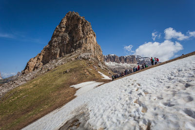 People standing on snowcapped mountain