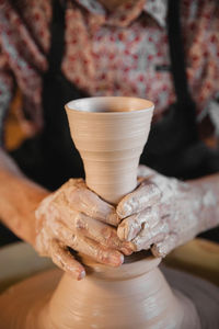 Close-up of man making pottery at workshop