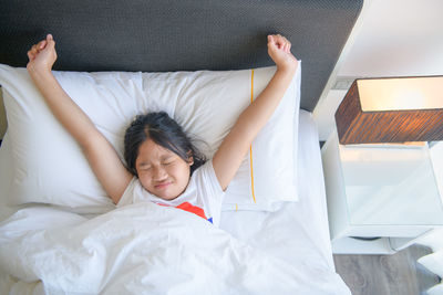 High angle view of baby sleeping on bed at home