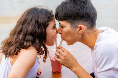 Mother and daughter drinking milkshake