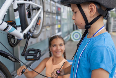 Rear view of young woman standing in factory