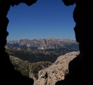 Scenic view of mountains against blue sky
