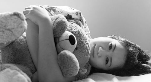 Close-up of woman hugging teddy bear