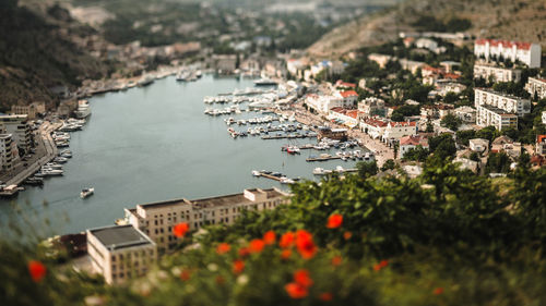 Boats moored in river along built structures