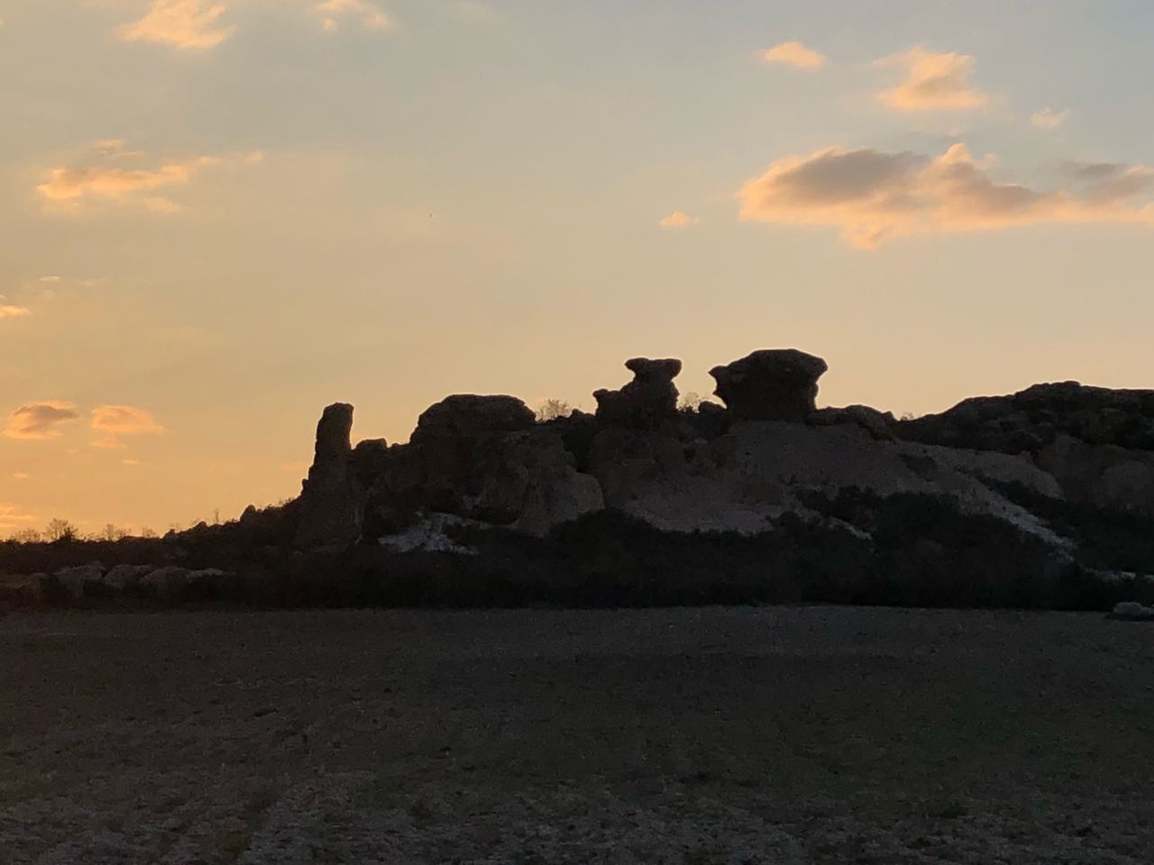 ROCK FORMATIONS ON LANDSCAPE AGAINST SKY DURING SUNSET