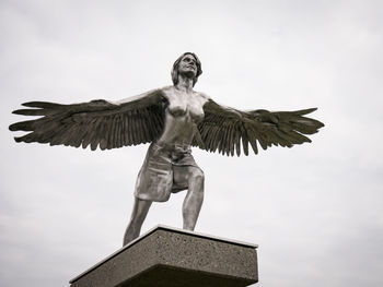 Low angle view of statue against sky