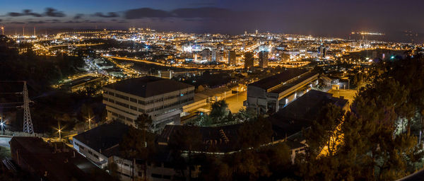 High angle view of city lit up at night