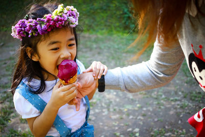 Portrait of girl blowing bubbles at home