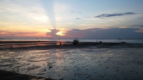 Scenic view of beach against sky during sunset