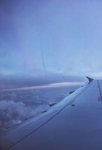 Aerial view of airplane wing against blue sky