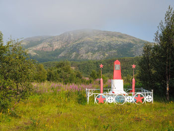 Lifeguard hut on field against sky