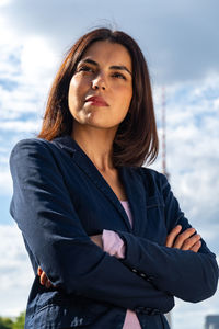 Beautiful woman standing against sky