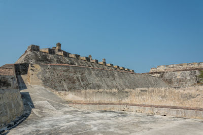 Low angle view of fort against blue sky