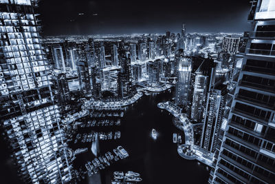 High angle view of illuminated modern buildings in city at night