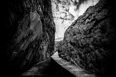 Narrow footpath amidst rock formation