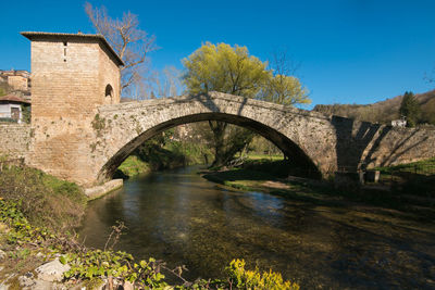 Arch bridge over river against sky subiaco italy