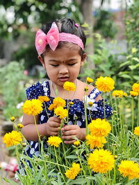 Portrait of a girl with yellow flowering plants