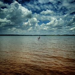 Scenic view of sea against cloudy sky