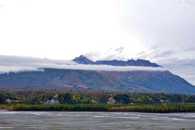 Scenic view of mountains and sea against sky