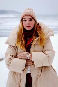 Portrait of beautiful woman standing in snow