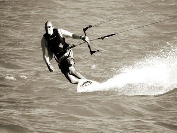 Full length of man kiteboarding in sea