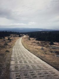 Road amidst landscape against sky