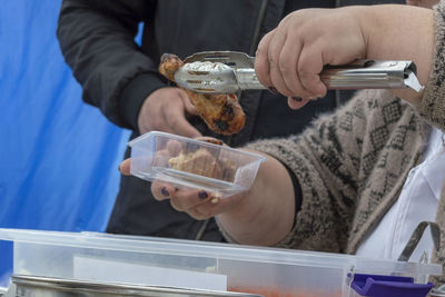 Midsection of woman packing food