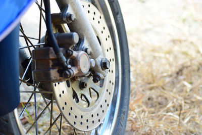 Close-up of bicycle wheel on field