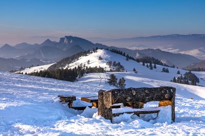 Built structure on snow covered field against sky