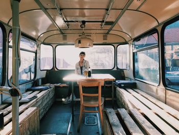 Portrait of man sitting in train