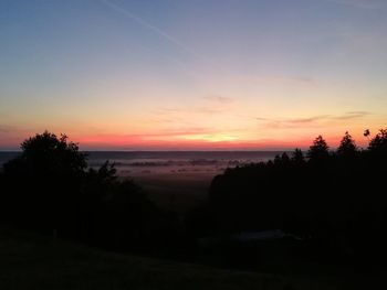 Scenic view of silhouette trees against sky during sunset