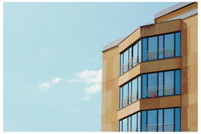 Low angle view of building against cloudy sky