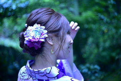 Rear view of woman with pink flower