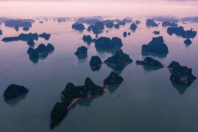 Rocks in sea against sky