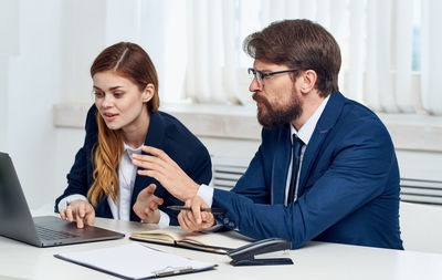 Young couple sitting on table at home