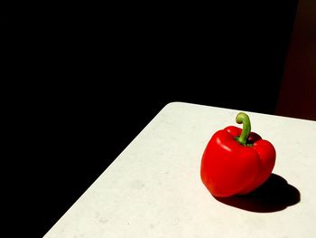 High angle view of red bell pepper on table against black background