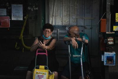 Portrait of friends standing against wall
