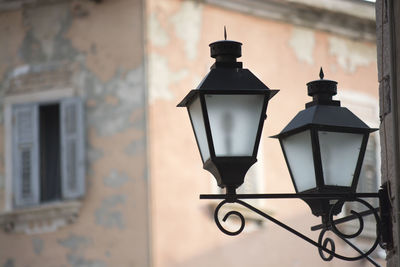 Close-up of street light against building