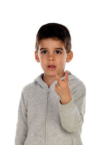 Portrait of boy standing against white background