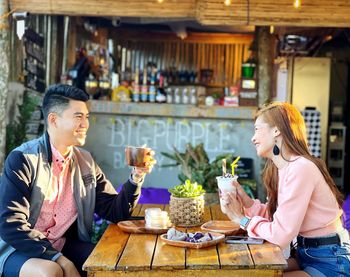 Young woman using mobile phone at restaurant