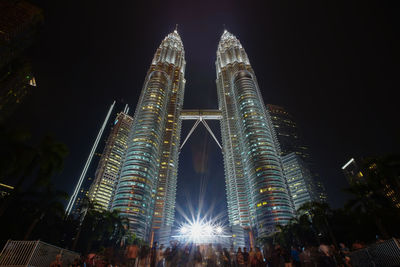 Low angle view of illuminated building against sky at night