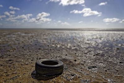 Close-up of sand on beach against sky